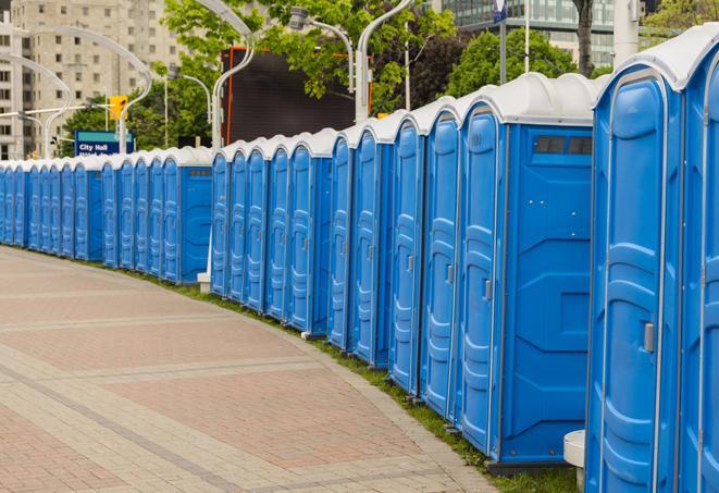 a line of brightly-colored portable restrooms, perfect for outdoor festivals and concerts in Bayou Vista